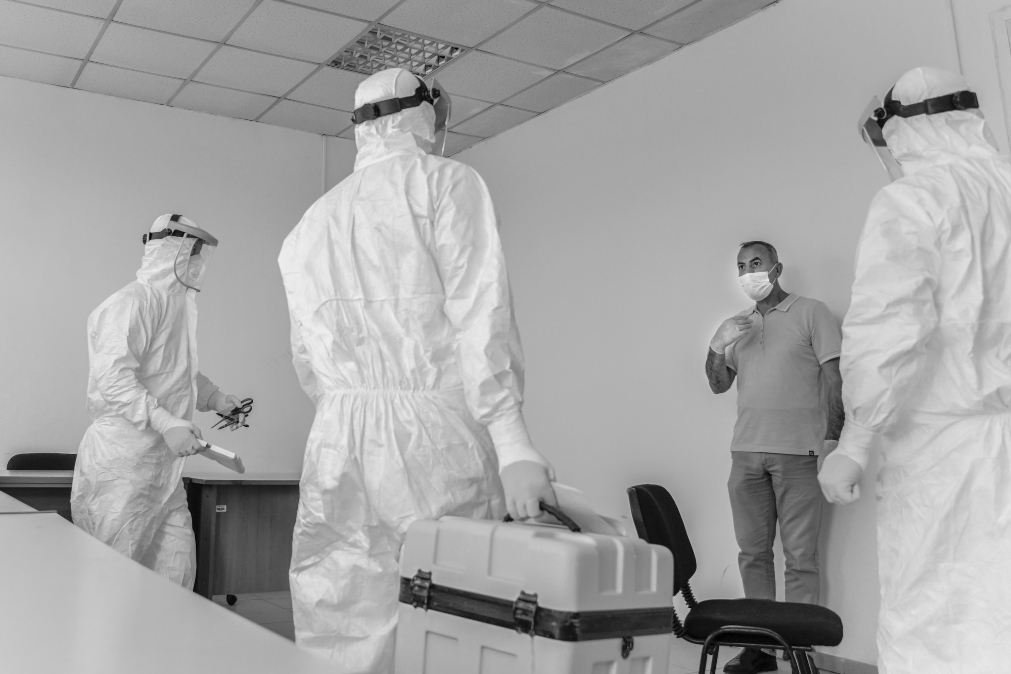 Some of those being tested are uncertain when they see the technicians in their full protective suits.