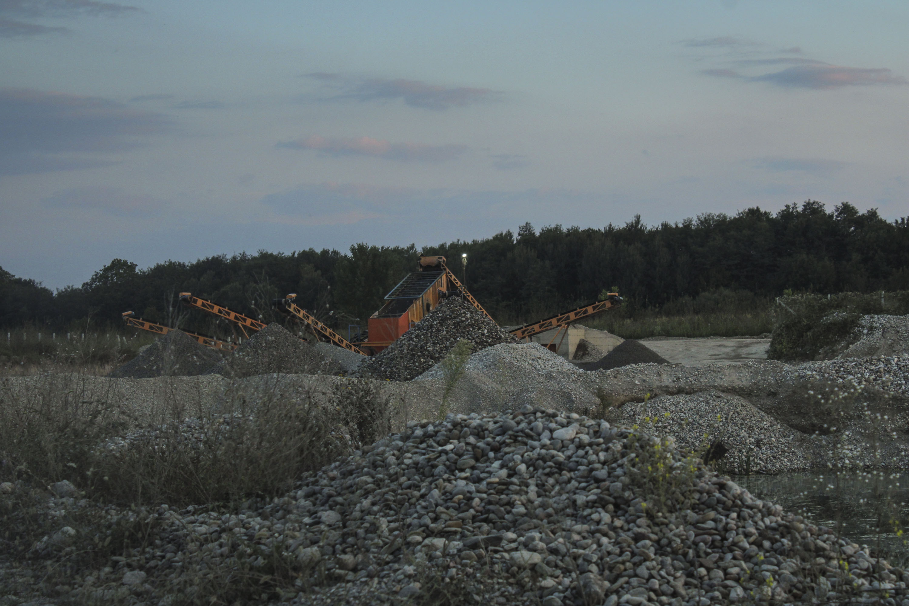 Sand and gravel mining with machines at the Lumbardhi river, Peja.