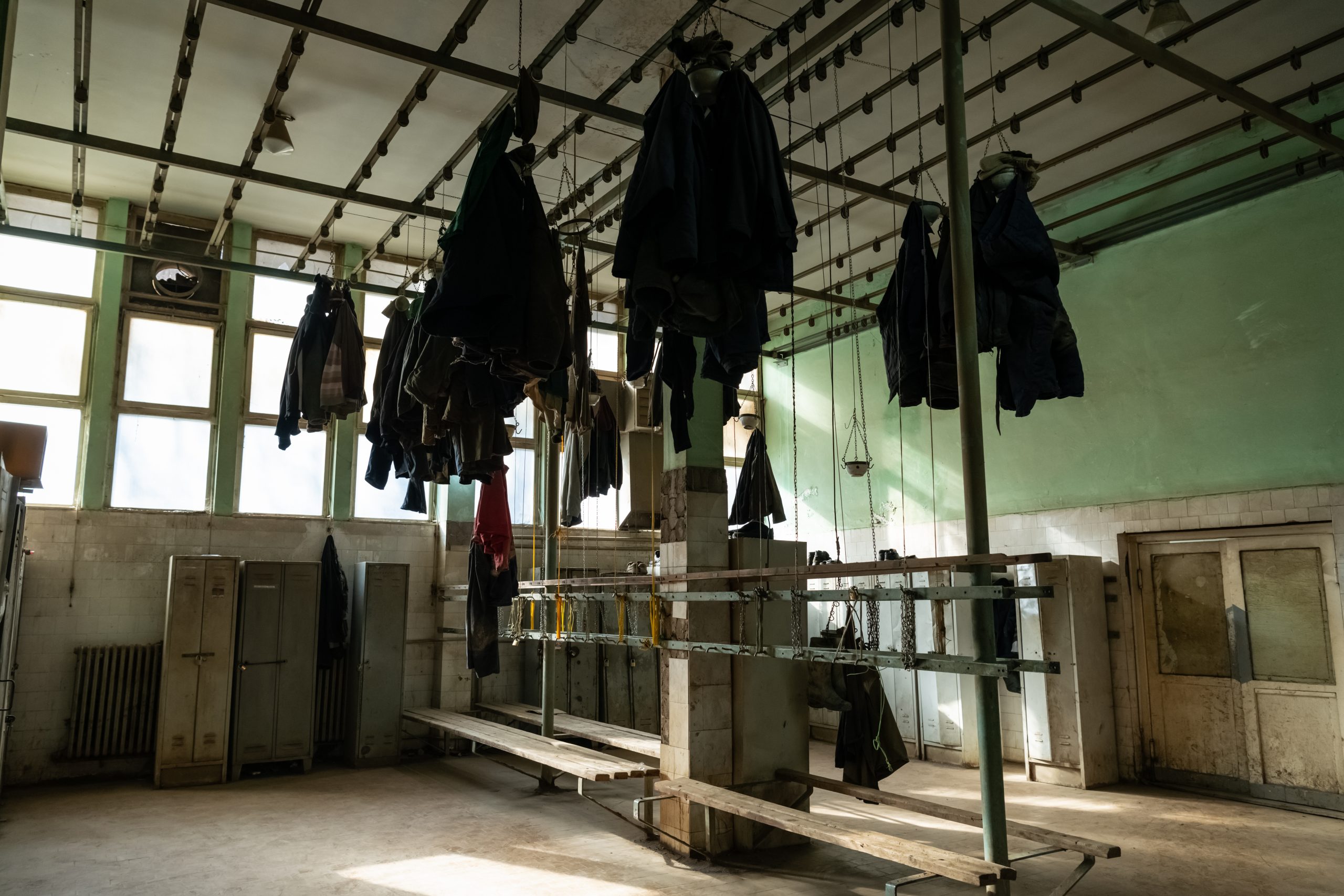 Uniforms hanging from the ceiling of the miners' changing room inside the Trepça facilities in Crnac.